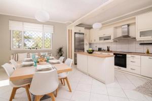 una cucina e una sala da pranzo con tavolo e sedie di Villa Zavria ad Argásion