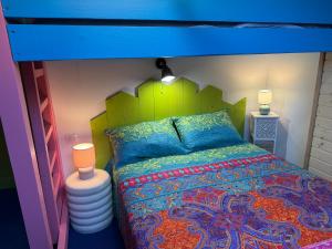 una camera con letto a castello e copriletto colorati di Chèvreroche a La Bresse