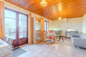 a living room with a couch and a table at La grange du Petit Roure - A 20 km de Saint-Etienne in Grand Roure