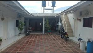 a room with two motorcycles parked next to a building at Hospedaje el floral in Tolú
