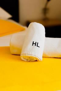 a roll of toilet paper with the word hil on it at London Rooms Zagreb Airport in Velika Gorica