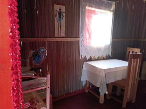 a small room with a table and a window at Maison Des Voyageurs in Ambanja