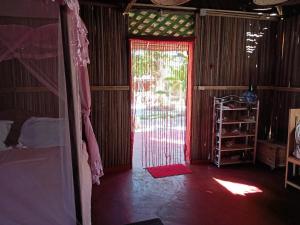 a room with a door open to a bedroom at Maison Des Voyageurs in Ambanja +14 photos