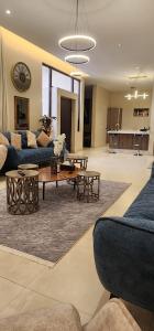 a living room with two blue couches and a table at Passion 1 Al arid شاليه باشن حي العارض in Riyadh