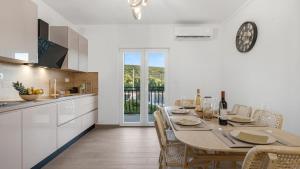 a kitchen and dining room with a table and chairs at Holiday house Hedonica by Villas Guide in Mirlović Zagora