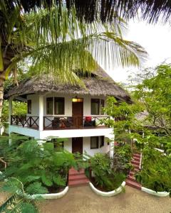 a small house with a thatched roof at pasha nungwi zanzibar in Nungwi