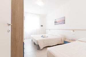 Кровать или кровати в номере MIMOSE Lido Altanea