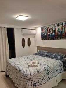 a bedroom with a bed with shoes on it at Gold Flat by Nomar Hospedagem 610 in João Pessoa