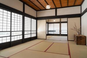 een lege kamer met grote ramen in een gebouw bij Kamogawa919 in Kamogawa