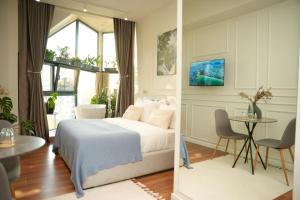 a bedroom with a bed and a table in a room at Moonlight Apartments Tirana in Tirana