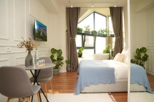 a bedroom with a bed and a table and chairs at Moonlight Apartments Tirana in Tirana