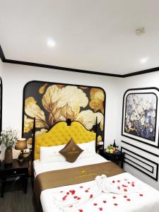 a bedroom with a large bed with hearts on it at Golden Hotel in Hanoi +84 photos