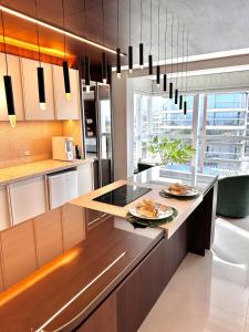 a kitchen with a island with food on it at Studio New York in Imbituba