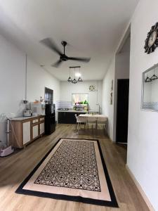 a living room with a rug on the floor at FMAZ Cottage in Kampong Gong