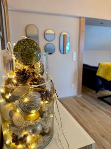 a glass vase filled with christmas decorations on a table at Danny's Wörtherseeblick in Schiefling am See