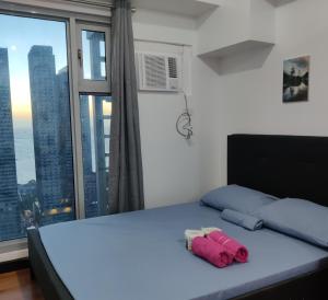 a bedroom with a bed and a large window at 8Adriatico Condo near US Embassy in Manila +24 photos