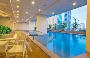 a swimming pool with a view of a building at 8Adriatico Condo near US Embassy in Manila