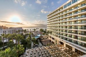 an overhead view of a building with a pool and palm trees at Sol Torremolinos - Don Marco Adults Recommended in Torremolinos