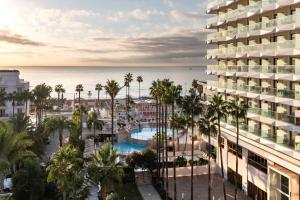 an aerial view of a resort with a pool and palm trees at Sol Torremolinos - Don Marco Adults Recommended in Torremolinos