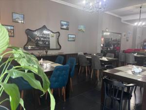 a dining room with tables and blue chairs at Aura Boutique Hotel in Batumi +10 photos