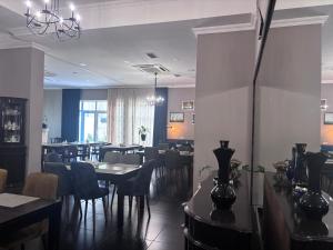 a dining room with tables and chairs in a restaurant at Aura Boutique Hotel in Batumi