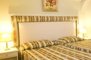 Rúm í herbergi á Park Hotel Villaferrata
