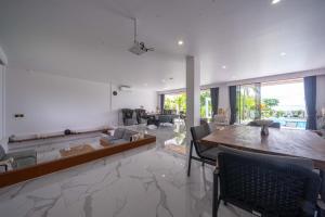 a large living room with a table and chairs at Gandum Villa Complex - Luxury Boutique Stay Uluwatu in Uluwatu