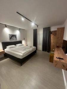 a large bedroom with a large bed and a table at Vacation Home Mo Star with Swimming pool and Sauna in Mostar +54 photos
