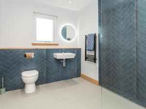a bathroom with a toilet and a sink at High Tide - Uk44283 in Gatehouse of Fleet +6 photos