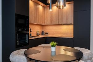 a kitchen with a table and chairs in a kitchen at Cosy River Suite in Tartu
