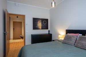 a bedroom with a bed and a door to a hallway at Cosy River Suite in Tartu