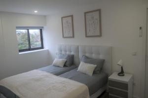 a bedroom with a bed and a window at Casas da Travessoa in Marco de Canaveses +139 photos