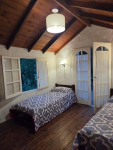 a bedroom with two beds and a wooden ceiling at Casa alameda in Mar de Cobo