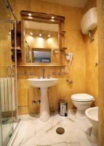 a bathroom with a sink and a toilet and a mirror at B&B Villa Mamma Rita in Tortora +36 photos