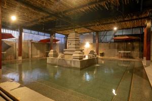 an empty swimming pool in a large building at The Full Hot Spring & Resort in Kemloko-gede