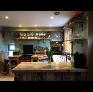 a kitchen with a table with a vase on it at Fisherman's Cottage in Orkney