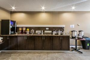 a kitchen with a counter and a counter top at Chinook Country Inn in Sundre