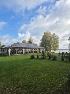 a pavilion in a park with a grass field at Siedlisko Pod Dębem in Wilimy