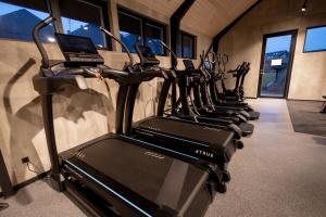 a row of treadmills in a gym with rows of treadms at Hotel Melfarhus - Your modern self-service hotel at the marina in Middelfart +51 photos