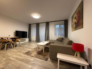 a living room with a couch and a table at The View Apartment 3 Bușteni in Buşteni