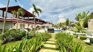 a resort with a swimming pool and palm trees at Hotel Soficu Green Village in Bayahibe