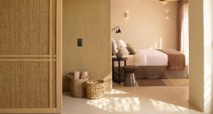 a bedroom with a bed in a room at Collini Hotel Mykonos, WorldHotels Elite in Fanari