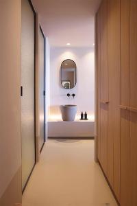 a bathroom with a sink and a mirror at Collini Hotel Mykonos, WorldHotels Elite in Fanari