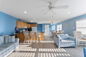 a living room with a couch and chairs and a kitchen at 235 E Spicer Ave, Unit A in Wildwood