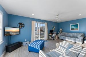 a living room with blue walls and a couch at 235 E Spicer Ave, Unit A in Wildwood