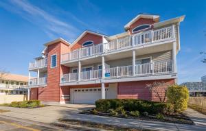 a red brick building with a balcony at 235 E Spicer Ave, Unit A in Wildwood