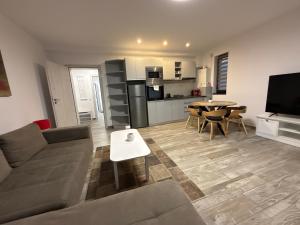a living room with a couch and a table at The View Apartment 3 Bușteni in Buşteni