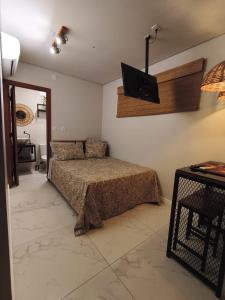 Containersblack في فلوريانوبوليس: غرفة نوم بها سرير وتلفزيون على الحائط