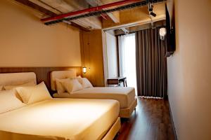 Una cama o camas en una habitación de Uukam by Bernalo Hotels