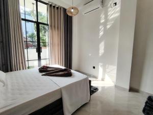 a bed in a room with a large window at One Love in Weligama